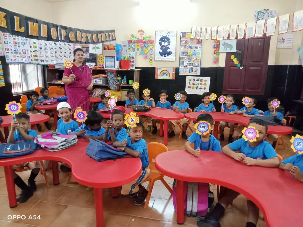 Kindergarten children holding letter flowers in a Montessori Magic classroom
